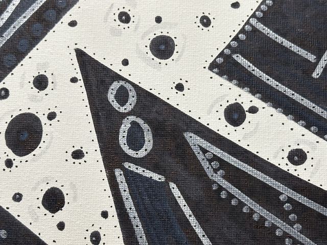 Stark black and white forms with dots and orbiting rings