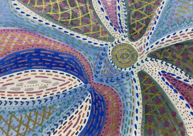 Pinwheel of patterned petals in blue, pink, and gold crosshatch