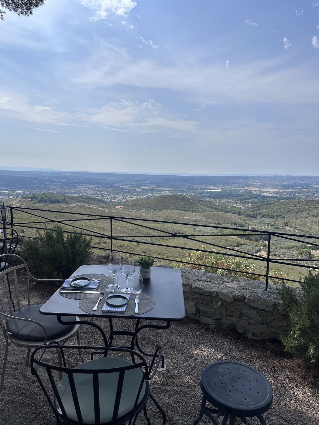 Café table on a terrace overlooking a hazy valley