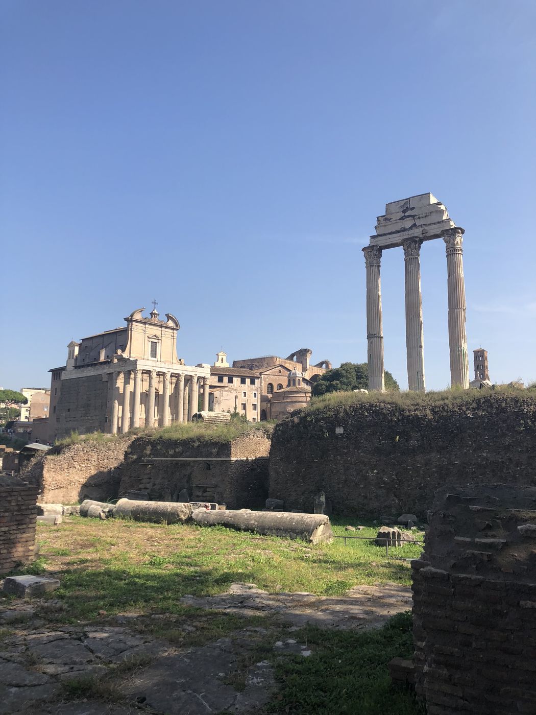 Columns and ruins of the Roman Forum under bright clouds