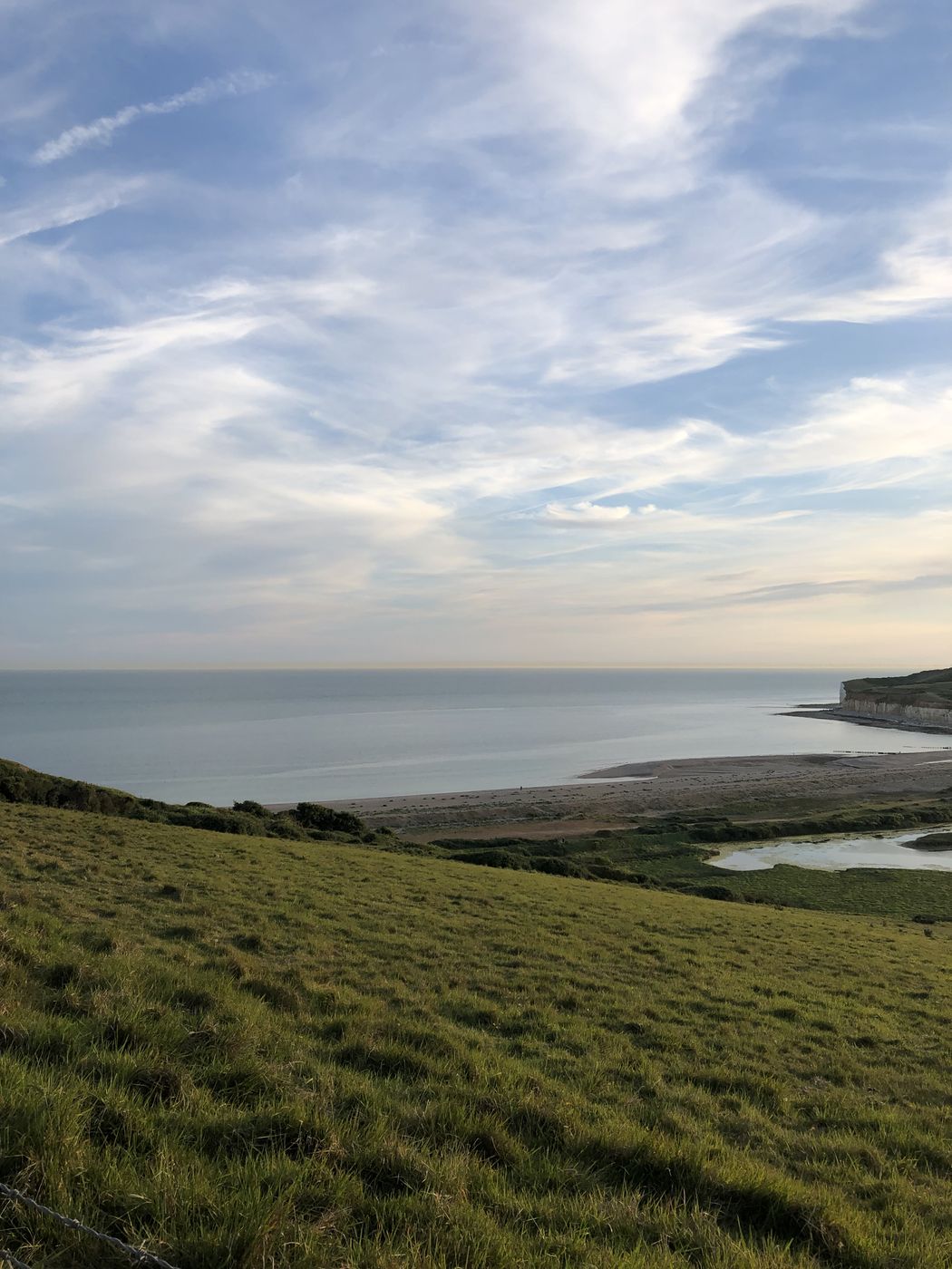 Green headland meeting the sea at the Seven Sisters cliffs